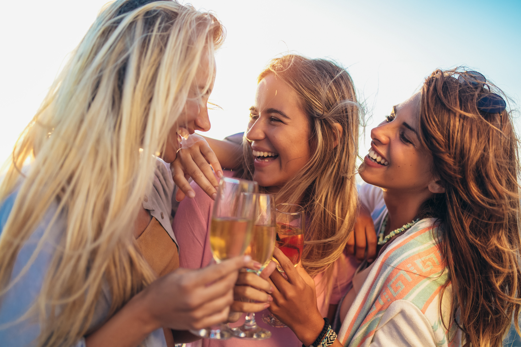 Happy young women drinking champagne at bachelorette party on the beach Newport RI Bachelorette Party Transport